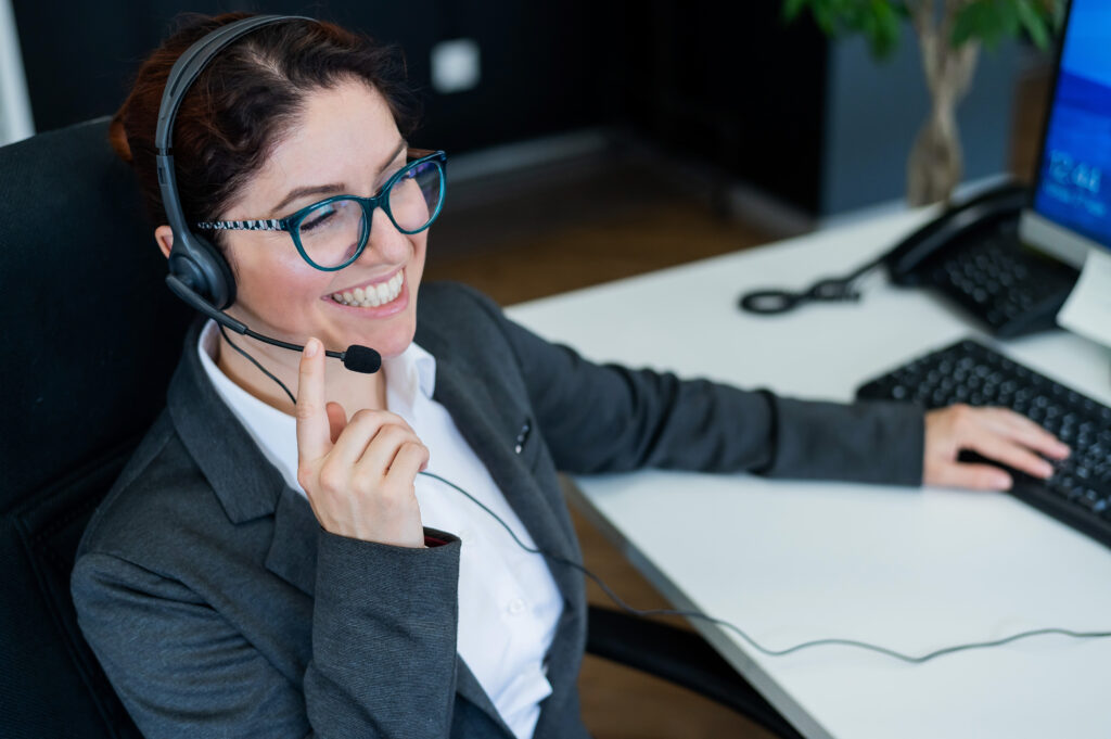 Receptionist answering the telephone and smiling